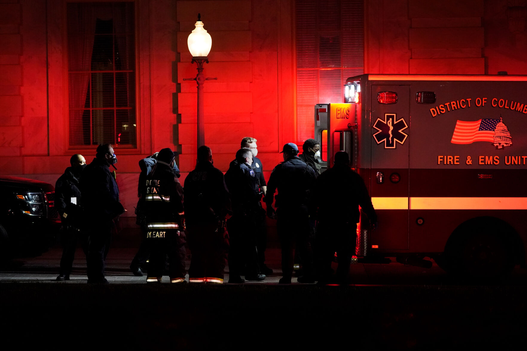 A person on a stretcher is placed in an ambulance